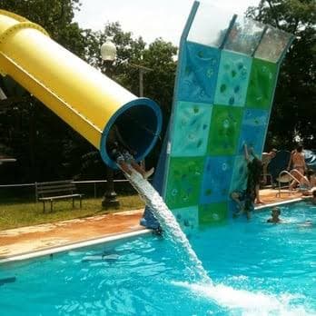 The drop slide and rock climbing wall on the competition pool at Menlo Aquatics Center